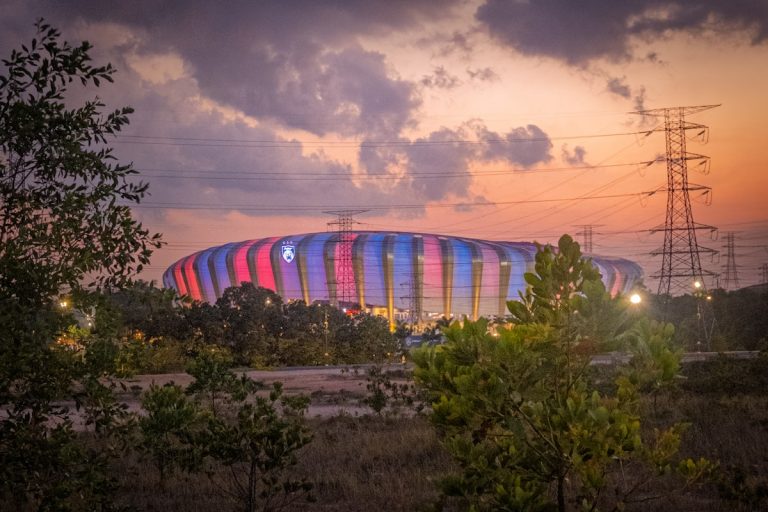Illuminated stadium under dramatic sunset - NBA Draft Night live coverage