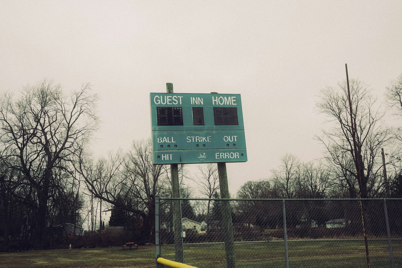 An outdoor baseball scoreboard with trees and fence behind it, used to illustrate how some sports metrics outlast the eras that produced them.
