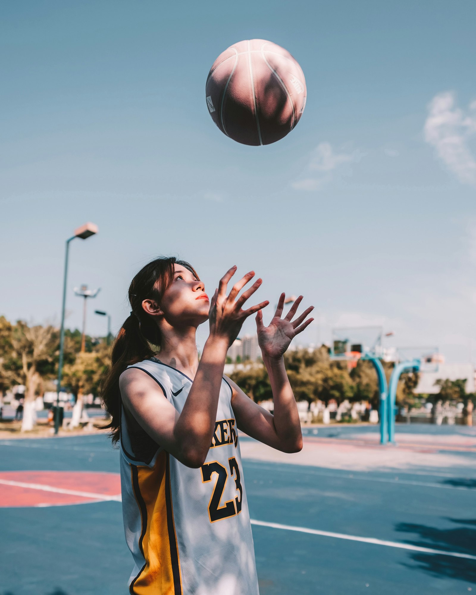 A basketball player reaching to grab the ball, used to illustrate the player-evaluation dimension of WNBA Draft analytics.