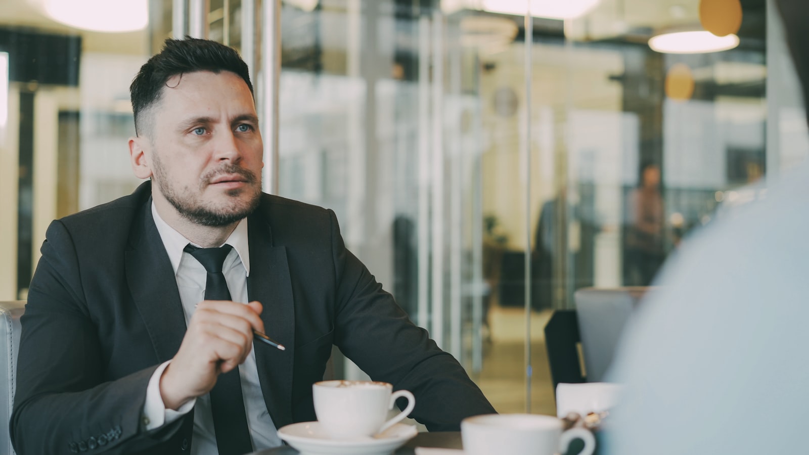 A man in a suit engaged in debate, used to illustrate the hot-take cycle that drives modern sports media coverage.