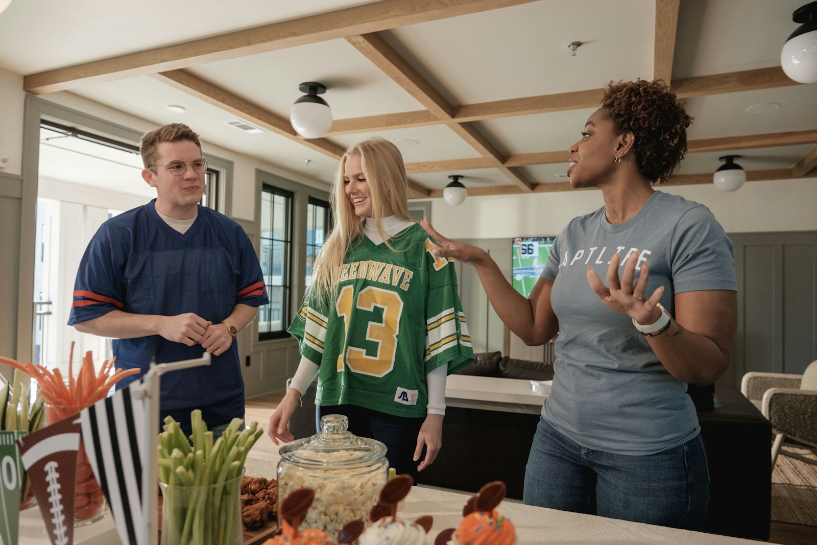 Three friends in jerseys discussing a sports game, used to illustrate how reading a match through both data and direct observation produces sharper analysis than either alone.