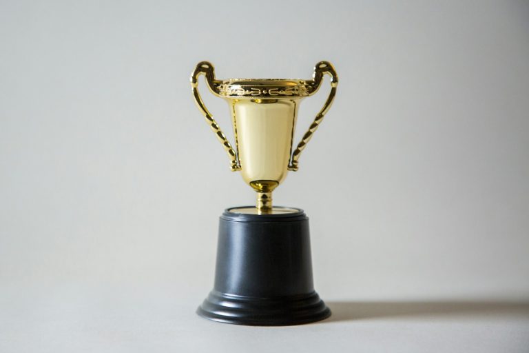 A yellow and white championship trophy, used to illustrate the NBA Finals MVP math and trophy projection.