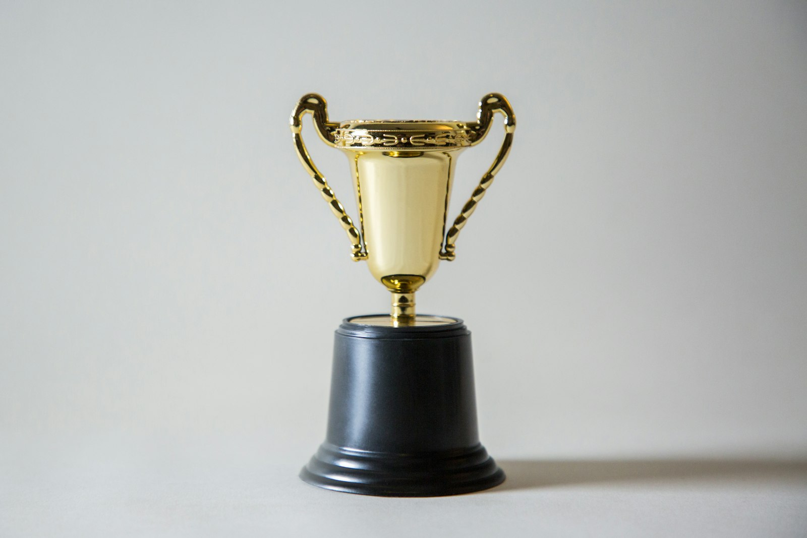 A yellow and white championship trophy, used to illustrate the NBA Finals MVP math and trophy projection.