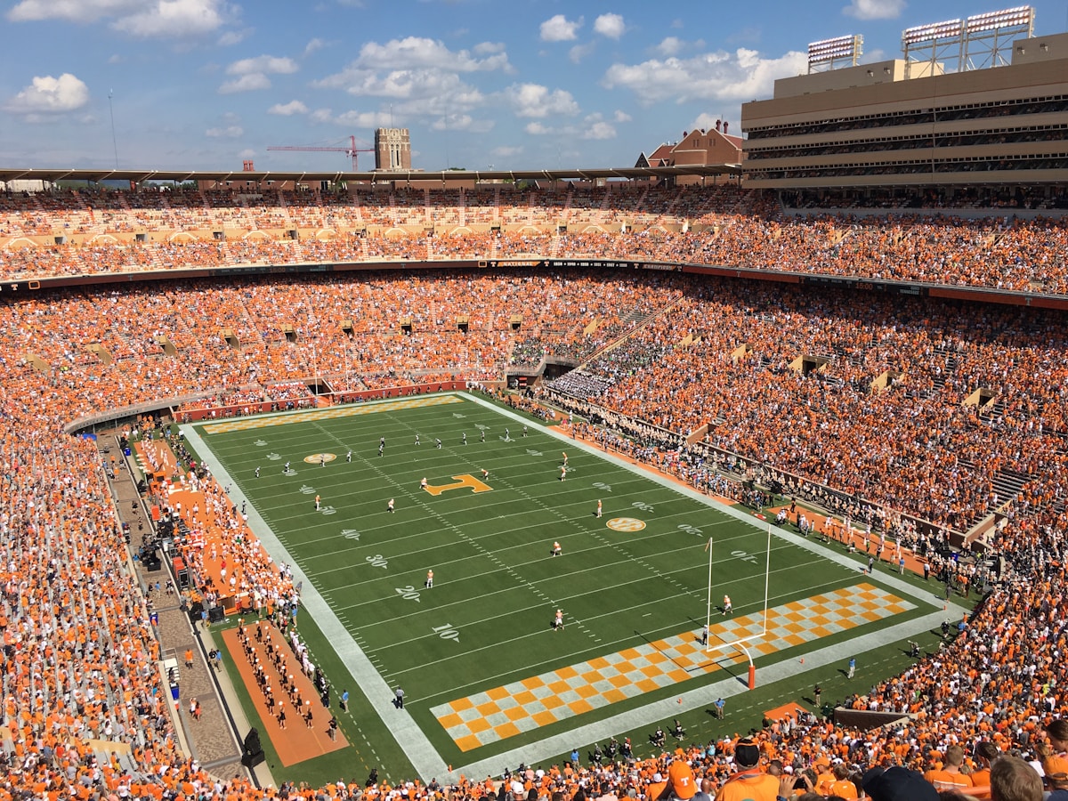 Green football field under blue sky - CFB Big 12 conference preview