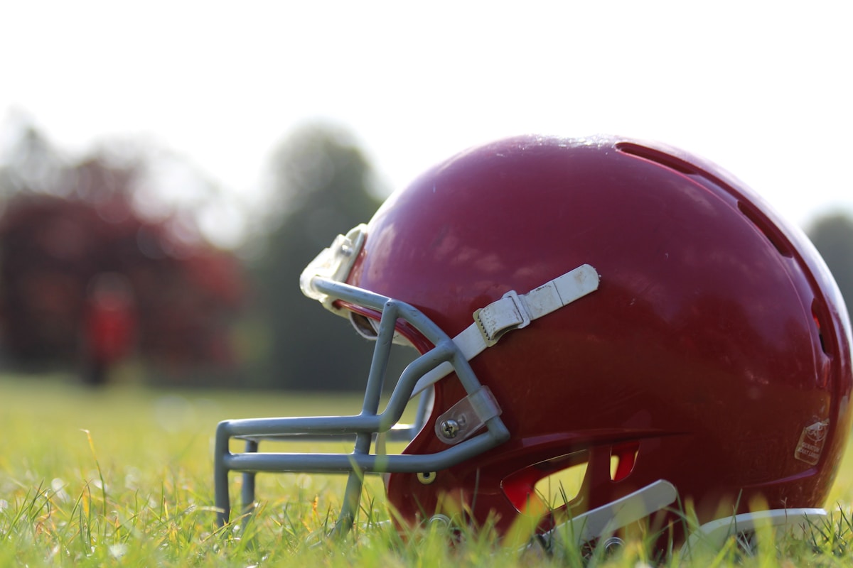 Red football helmet on green grass - NFL Preseason preview