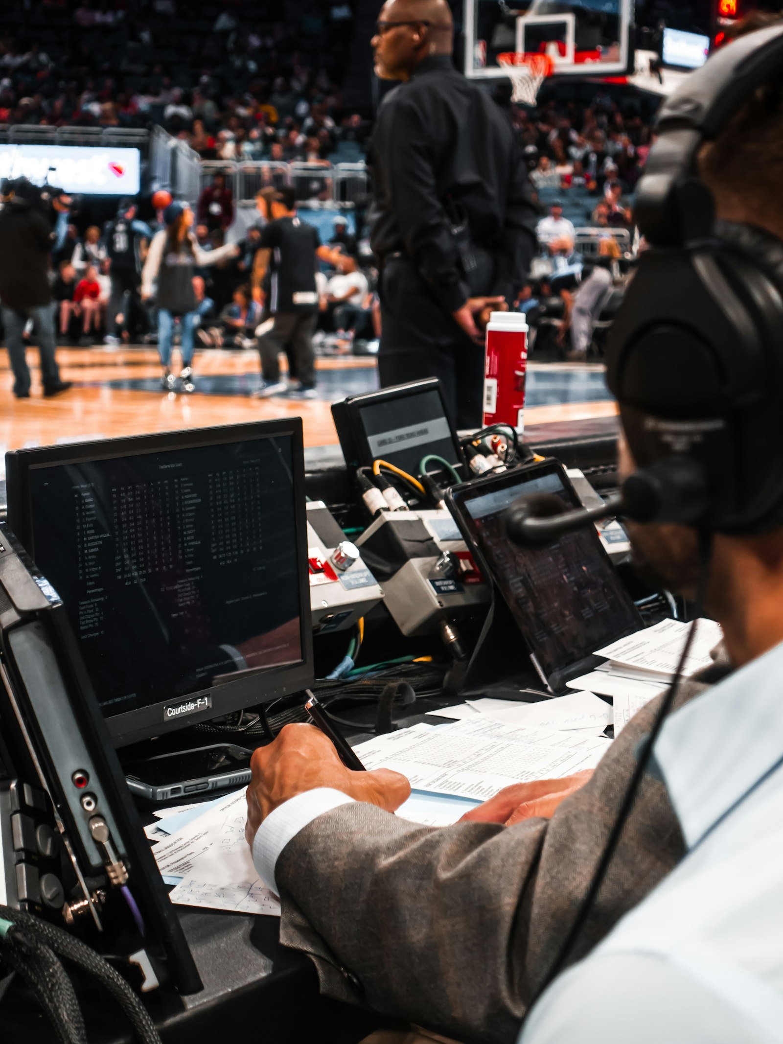 A person working on a laptop, used to illustrate the modern sports media workflow that turns individual numbers into season-long narratives.
