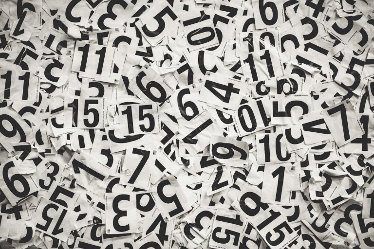 Scattered black numbers on a white paper background, used to illustrate the Leicester Problem and the way expected goals reads numbers against the result.