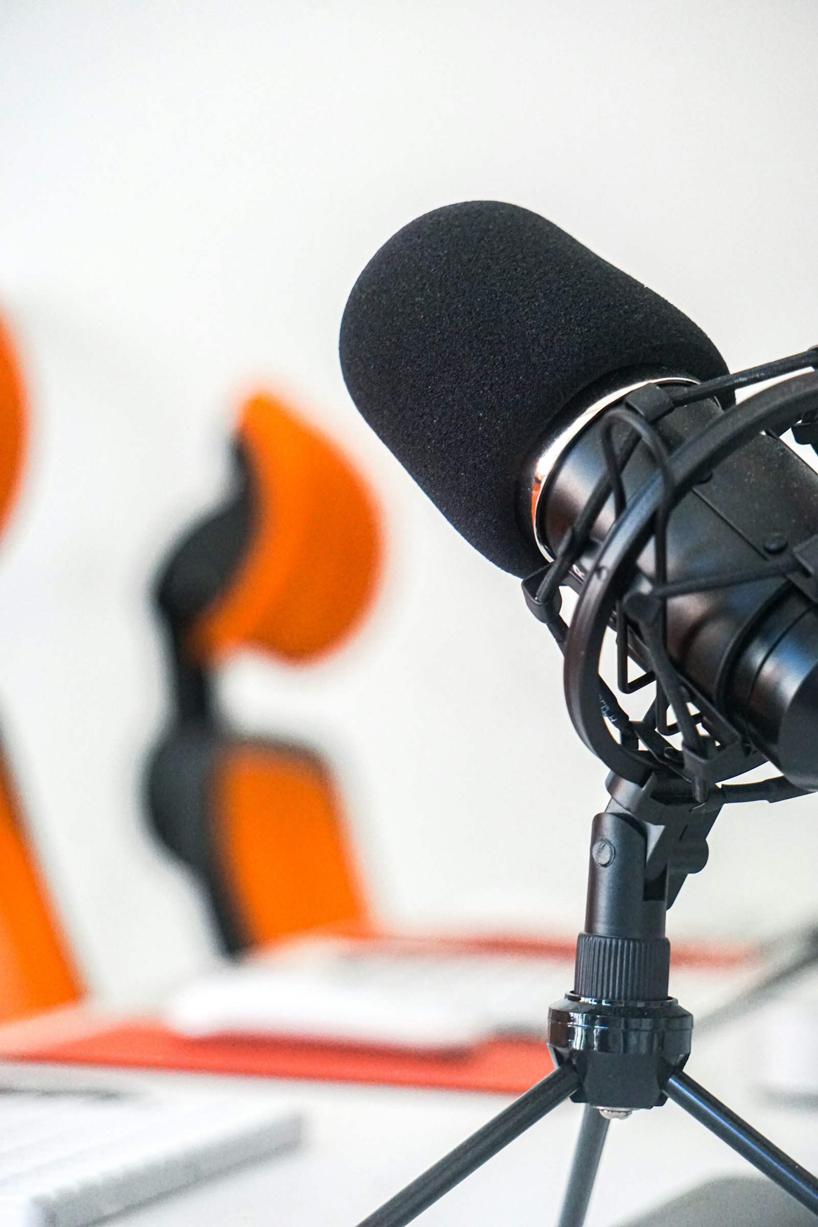 A professional black microphone on a stand, used to illustrate the production infrastructure that surrounds modern data-heavy sports newsrooms.