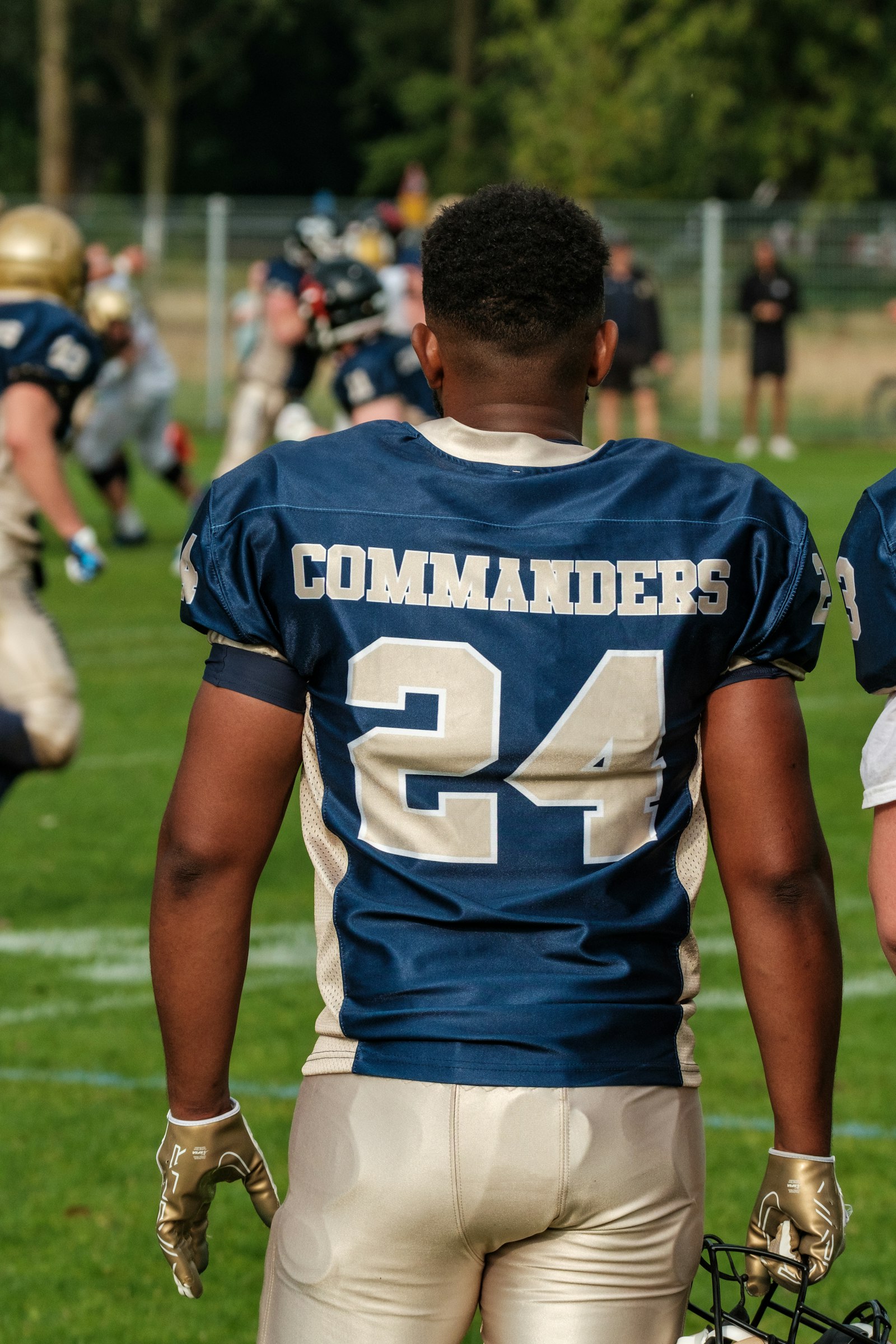NFL player in a Washington Commanders #24 jersey on the field, used to illustrate the kind of game footage that underlies success rate and EPA play-by-play data.