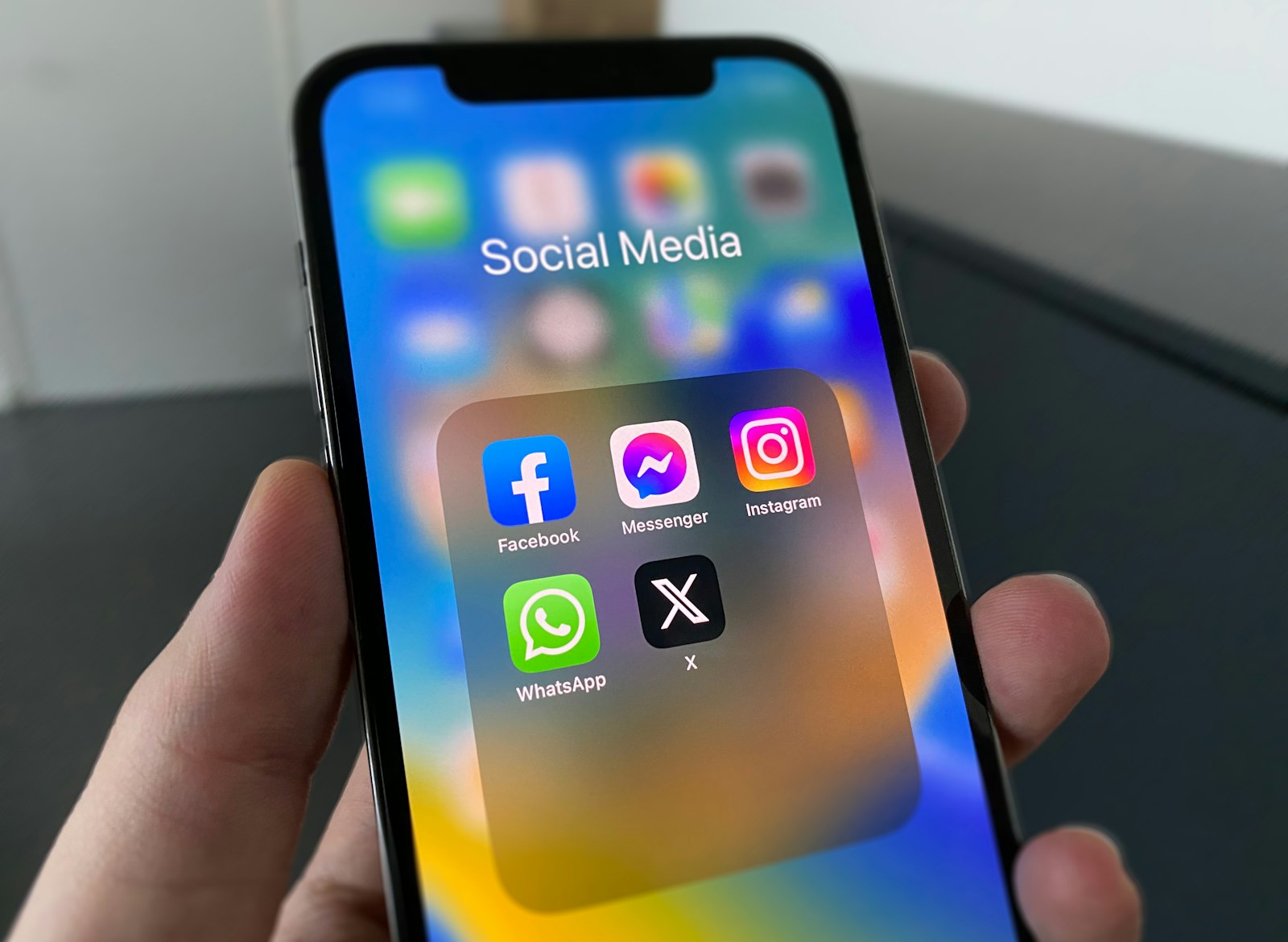 A person holding a phone with social media app icons, used to illustrate the fragmented sports coverage landscape across long-form and platform-specific formats.