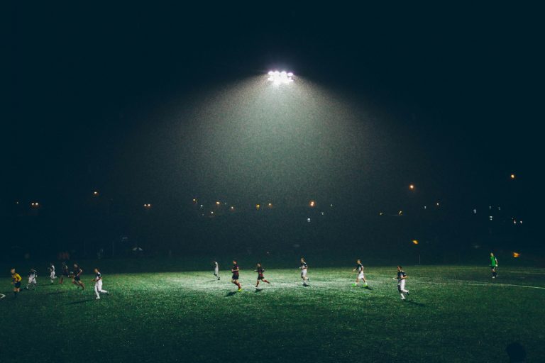A midfielder on the ball in the central third, looking up to spot a pass.