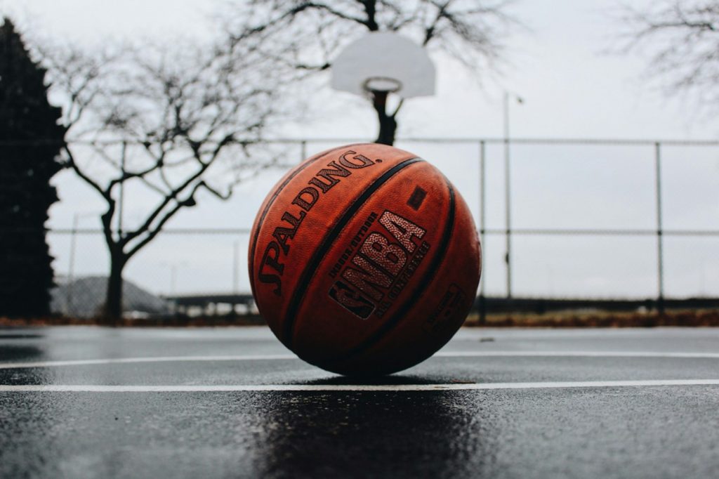 Basketball on a wet outdoor court, used for usage rate analysis