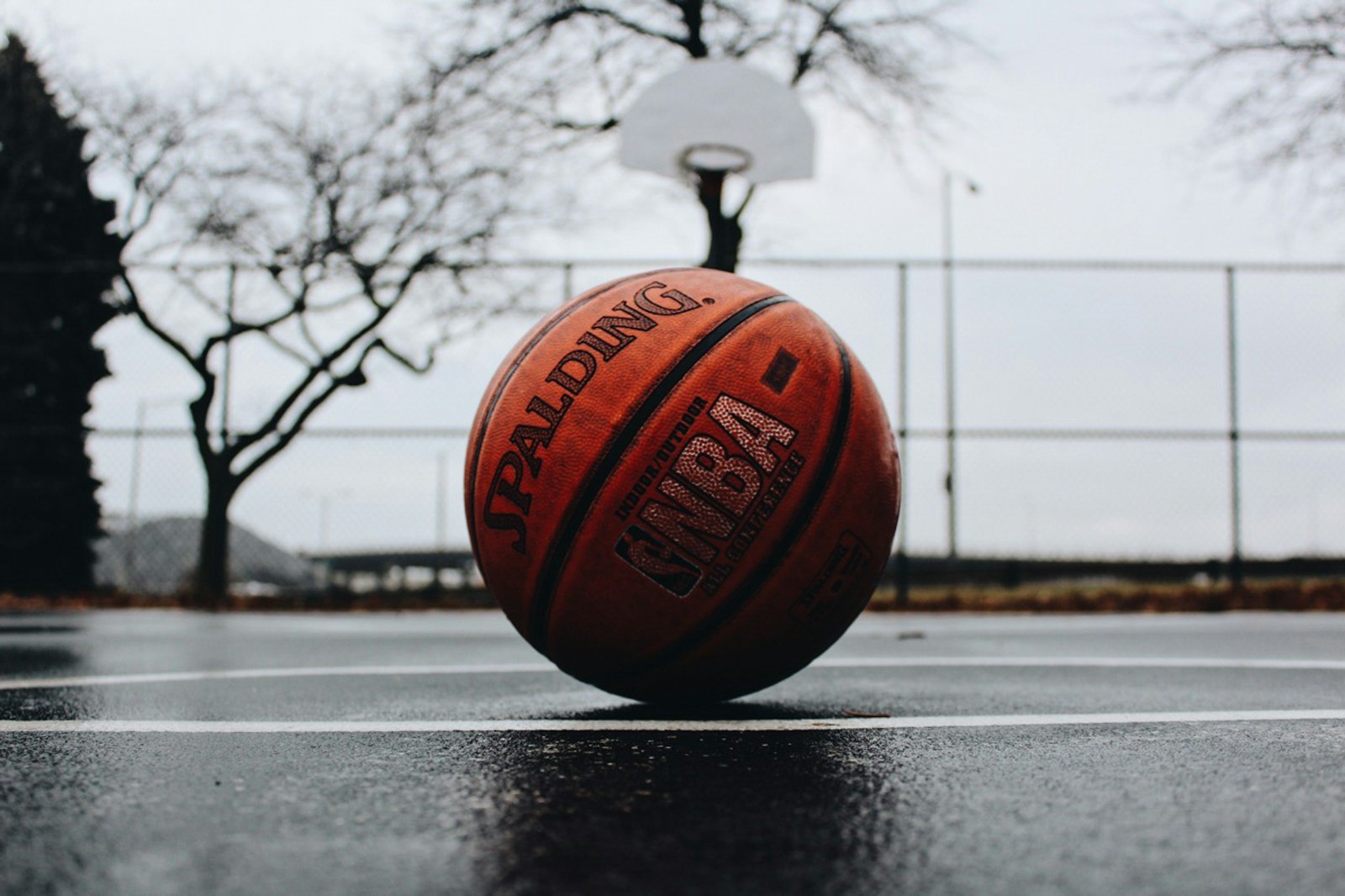 Basketball on a wet outdoor court, used for usage rate analysis