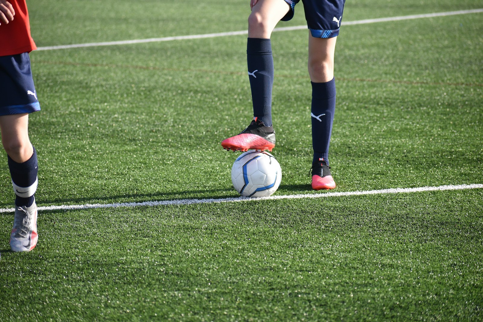 A soccer player kicking the ball during a match, used to illustrate the kind of action that pressing data tries to quantify and where the public models still struggle.