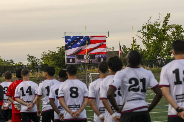 Soccer players standing in stadium with large American flag - USMNT World Cup 2026 preview