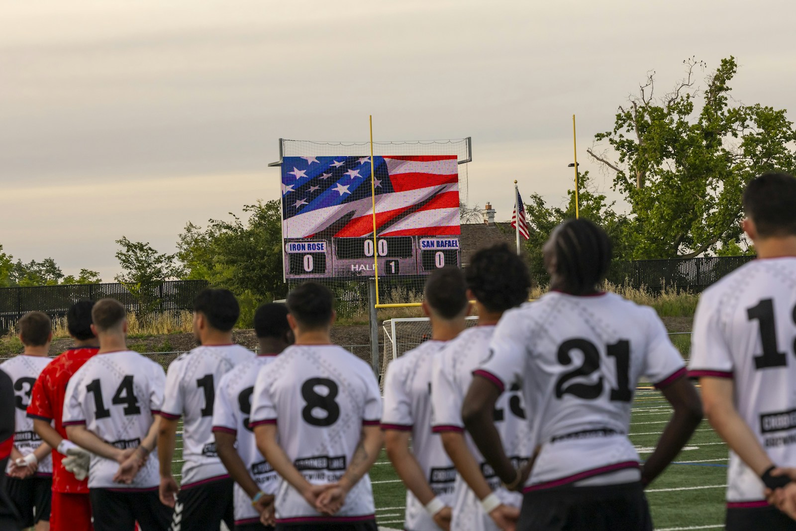 Soccer players standing in stadium with large American flag - USMNT World Cup 2026 preview