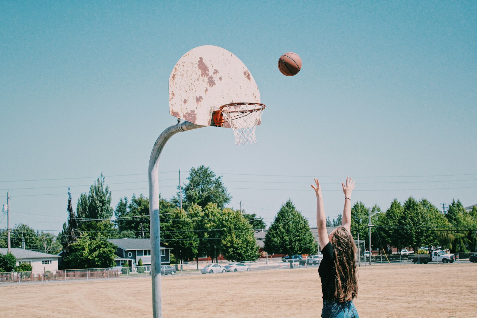 A woman in athletic gear on a basketball court, used to illustrate the modern WNBA spacing and pace analytics that drive offensive evolution.