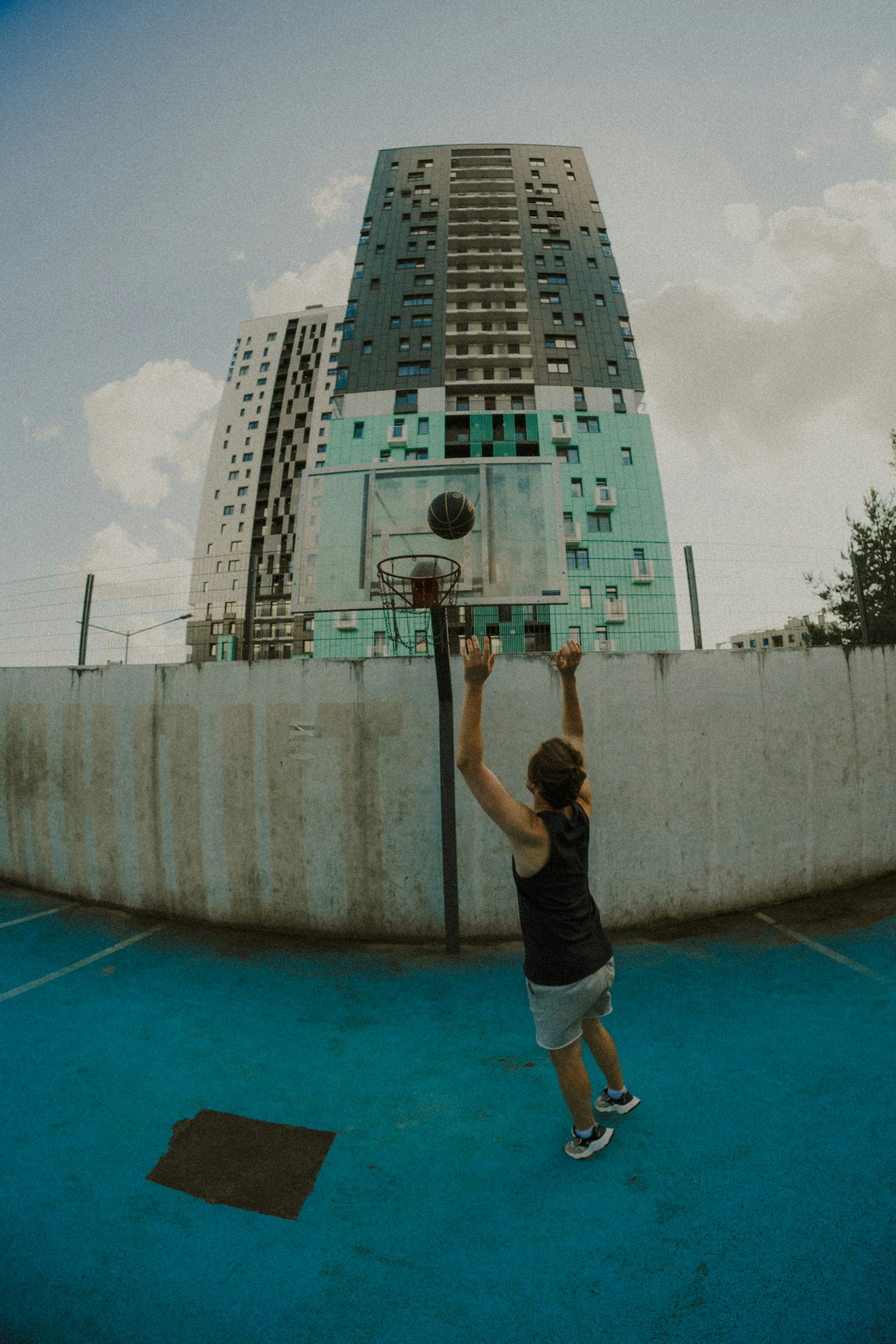 A woman shooting a basketball in an urban court setting, used to illustrate the usage-rate dynamics that shape WNBA player evaluation.