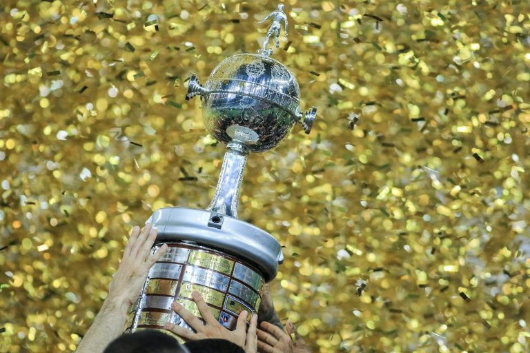 Person lifting trophy in confetti shower - Super Bowl LIX Eagles tush push postmortem