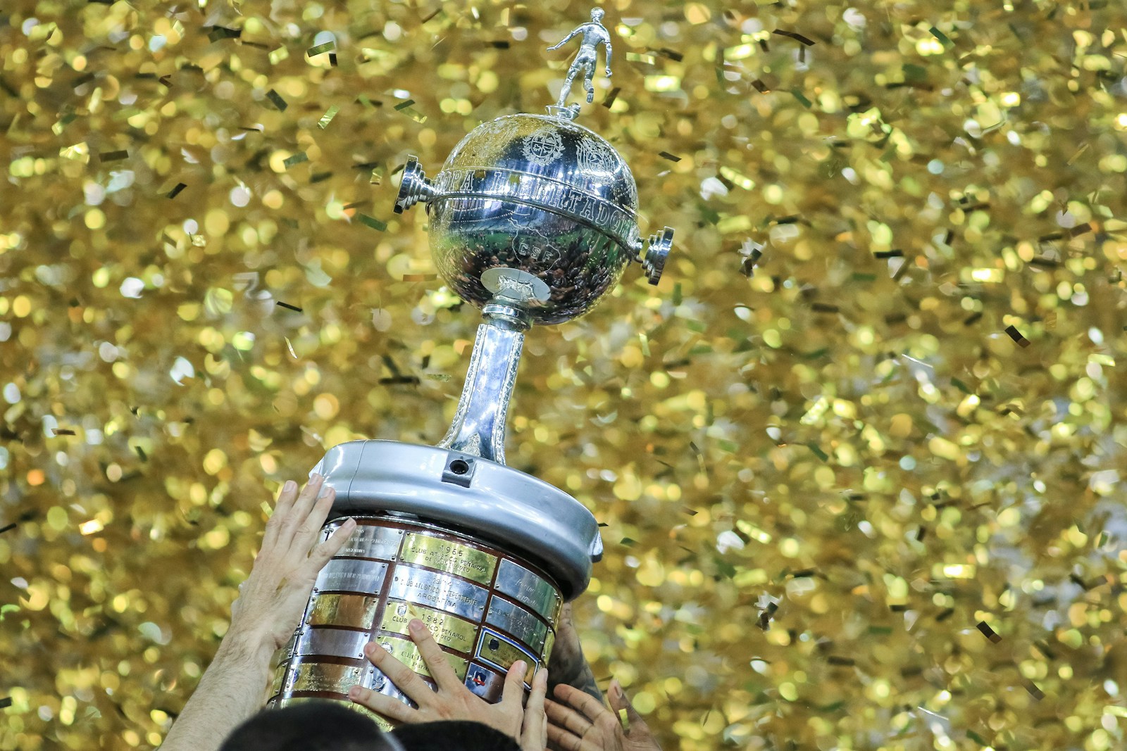 Person lifting trophy in confetti shower - Super Bowl LIX Eagles tush push postmortem
