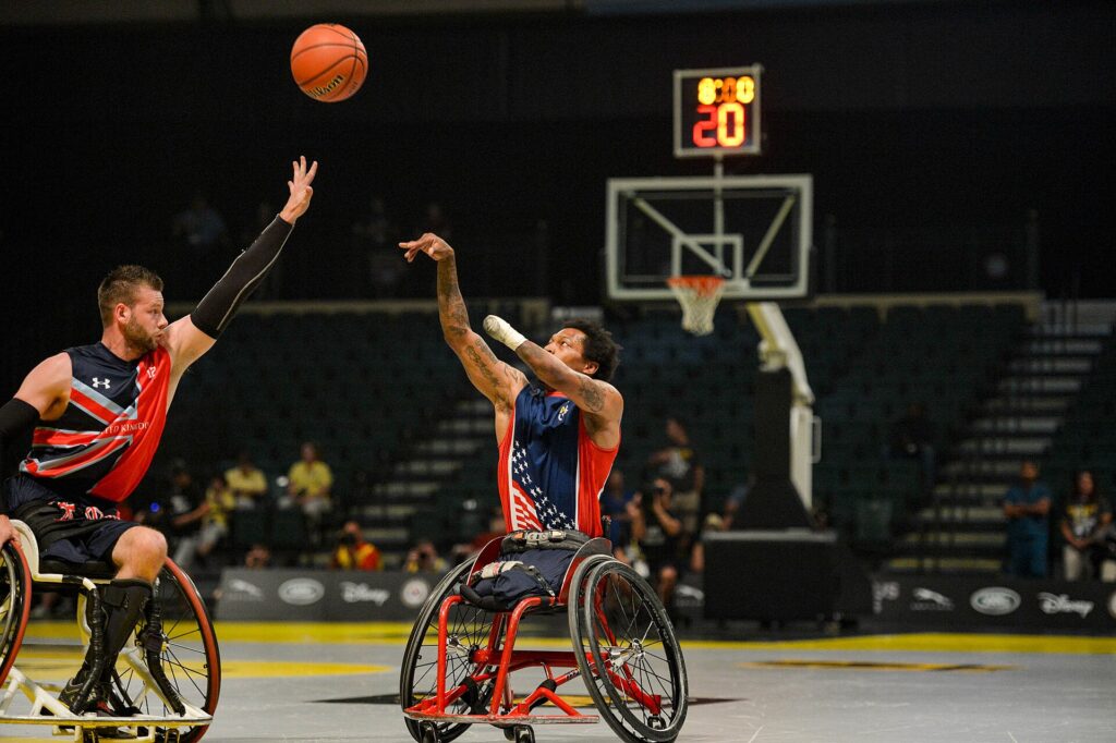 A tall defender staying in front of a smaller ball handler out beyond the three point line