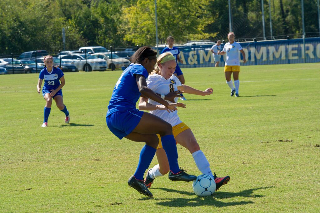 Two defenders turning to track a forward's run in behind the defensive line