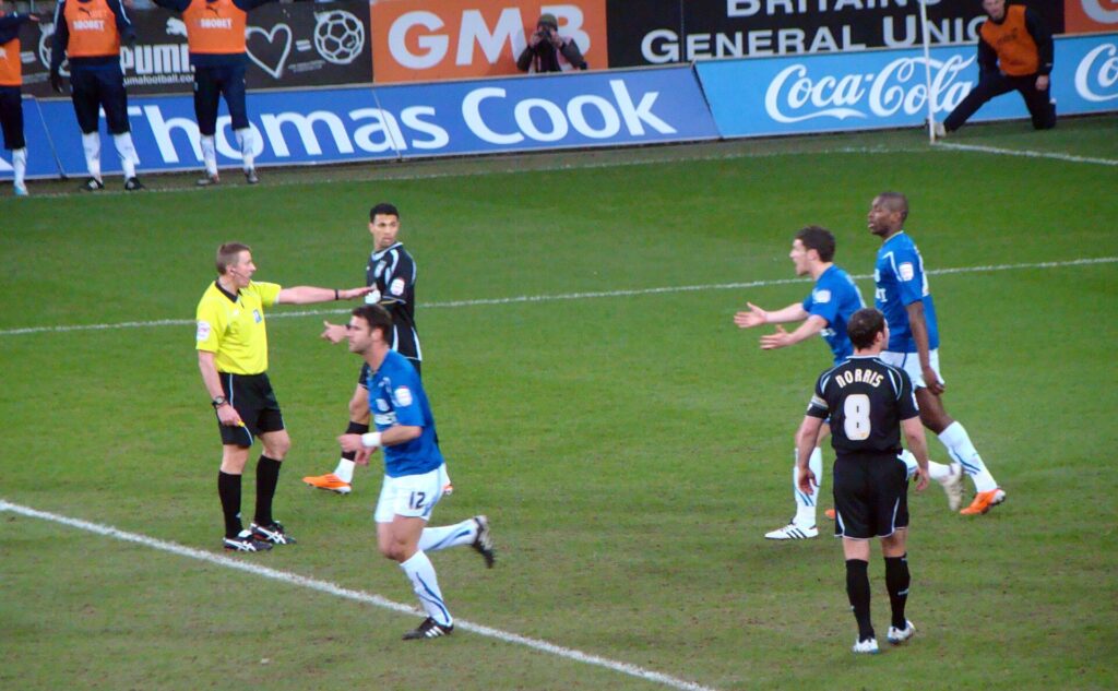 A television broadcast graphic showing a colored offside line overlaid on a soccer pitch
