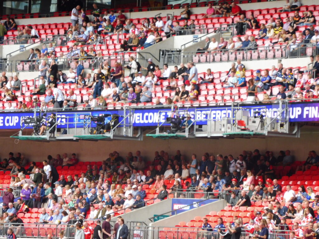 A fixed camera position high in a stand overlooking the full width of the pitch